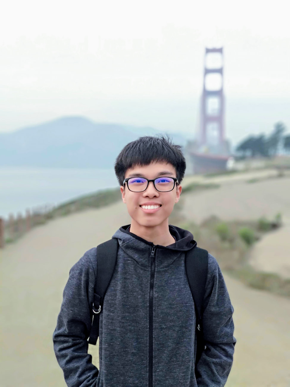 Henry Lim with his dark gray parka at Golden Gate Overlook, San Francisco.